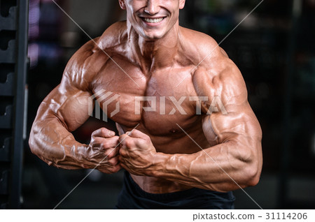Handsome power athletic man on diet training pumping up muscles Handsome power athletic man on diet training pumping up muscles 31114206