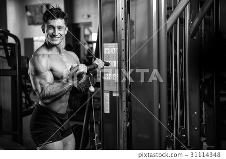 Handsome power athletic man on diet training pumping up muscles Handsome power athletic man on diet training pumping up muscles 31114348