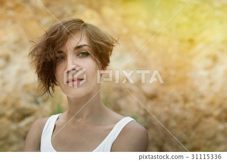Young woman outdoors portrait. Soft sunny colors. Young woman outdoors portrait. Soft sunny colors. 31115336