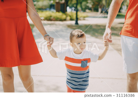 beautiful family in red walking down the street 31116386