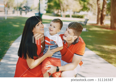 beautiful family in red walking down the street 31116387