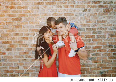 beautiful family in red walking down the street beautiful family in red walking down the street 31116403