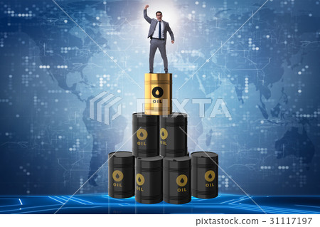 Businessman on top of oil barrels 31117197