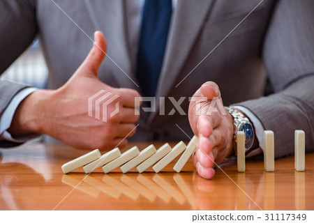 Businessman with dominoes in the office 31117349