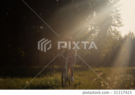 Funny girl driving bicycle outdoor. Sunny summer Funny girl driving bicycle outdoor. Sunny summer 31117423