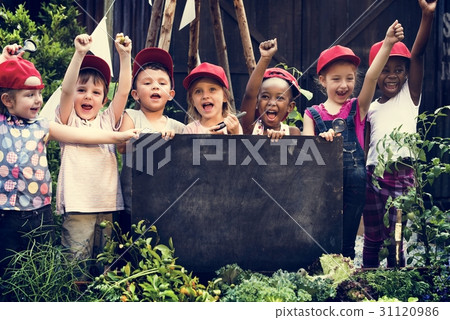 Group of children holding blank blackboard in garden Group of children holding blank blackboard in garden 31120986