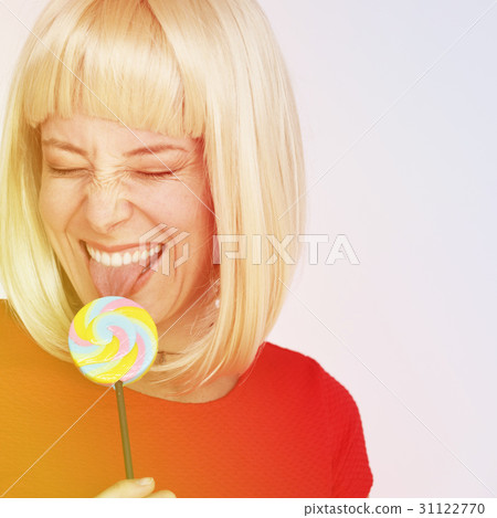Woman happiness face expression while eating lollipop Woman happiness face expression while eating lollipop 31122770
