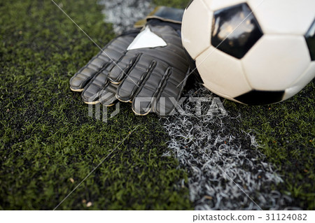 soccer ball and goalkeeper gloves on field soccer ball and goalkeeper gloves on field 31124082