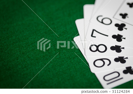 poker hand of playing cards on green casino cloth poker hand of playing cards on green casino cloth 31124284