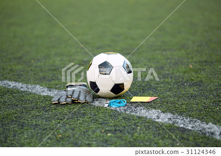 ball, gloves, whistle and cards on soccer field ball, gloves, whistle and cards on soccer field 31124346