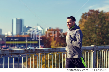 happy young man running over city bridge happy young man running over city bridge 31124503