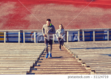 happy couple running upstairs on stadium 31124719