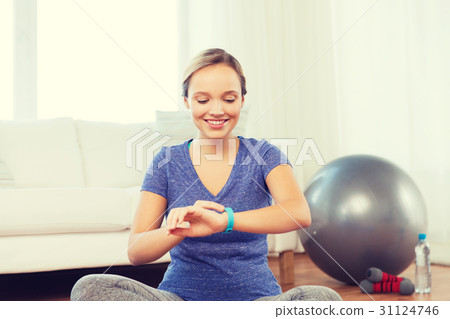 happy woman with heart-rate watch exercising happy woman with heart-rate watch exercising 31124746