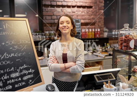 happy woman or barmaid at cafe counter 31124920