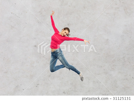 happy young woman jumping in air or dancing happy young woman jumping in air or dancing 31125131