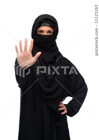 muslim woman in hijab showing stop sign 31125263
