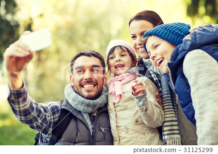 family taking selfie with smartphone outdoors family taking selfie with smartphone outdoors 31125299