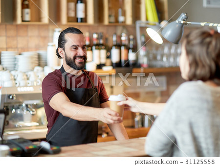 man or waiter serving customer in coffee shop 31125558