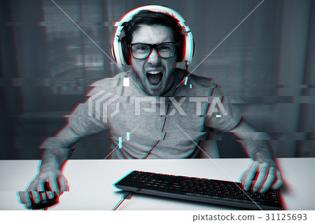 man in headset playing computer video game at home 31125693