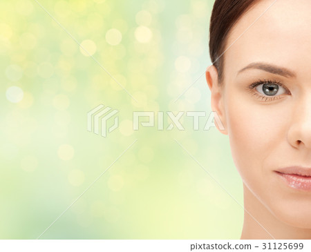 beautiful young woman half face over green beautiful young woman half face over green 31125699