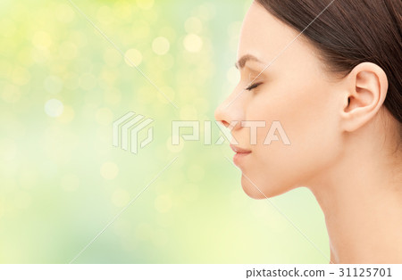beautiful young woman face over green background beautiful young woman face over green background 31125701