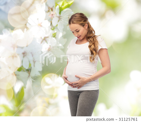 happy pregnant woman touching her big belly happy pregnant woman touching her big belly 31125761