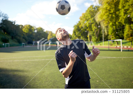 soccer player playing with ball on field soccer player playing with ball on field 31125805
