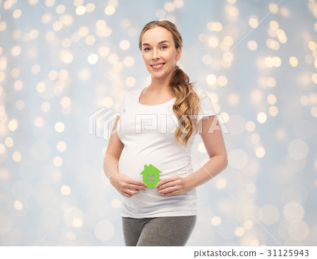 happy pregnant woman with green house happy pregnant woman with green house 31125943
