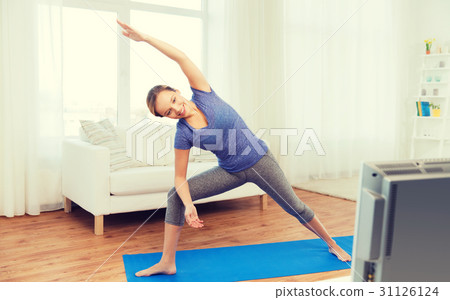 woman making yoga bikram triangle pose on mat woman making yoga bikram triangle pose on mat 31126124