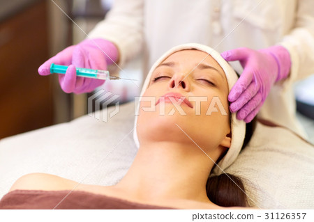 beautician doing beauty injection to woman lips beautician doing beauty injection to woman lips 31126357