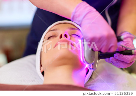 young woman having face microdermabrasion at spa 31126359