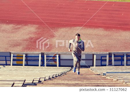 man running upstairs on stadium 31127062