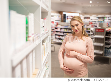 pregnant woman at pharmacy or cosmetics store pregnant woman at pharmacy or cosmetics store 31127308