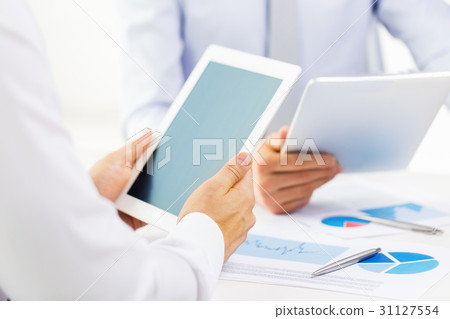 businesswomen with tablet pc and charts at office businesswomen with tablet pc and charts at office 31127554