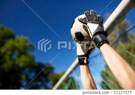 goalkeeper with ball at football goal on field 31127577