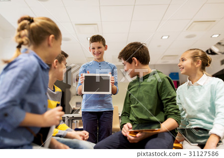 group of happy children with tablet pc at school group of happy children with tablet pc at school 31127586