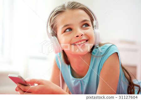 close up of girl with smartphone and headphones 31127604