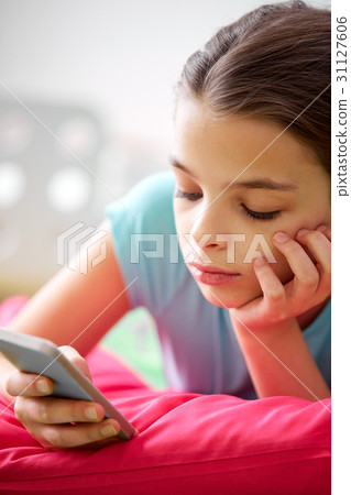 close up of bored girl with smartphone at home close up of bored girl with smartphone at home 31127606