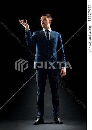 businessman in suit holding something invisible businessman in suit holding something invisible 31127632