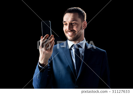 businessman with transparent smartphone businessman with transparent smartphone 31127633