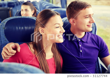 happy teenage couple or passengers in travel bus 31127744