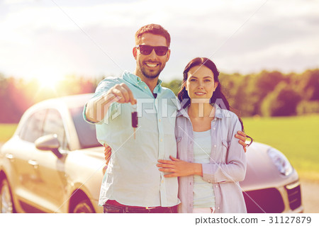 happy man and woman with car key hugging happy man and woman with car key hugging 31127879
