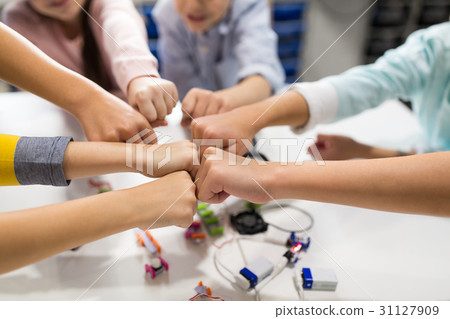 happy children making fist bump at robotics school 31127909