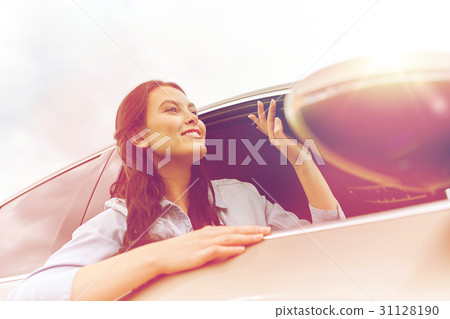 happy young woman driving in car 31128190