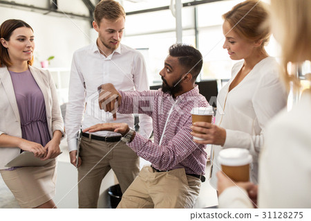happy business team drinking coffee at office happy business team drinking coffee at office 31128275