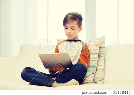 boy with tablet computer at home 31128413