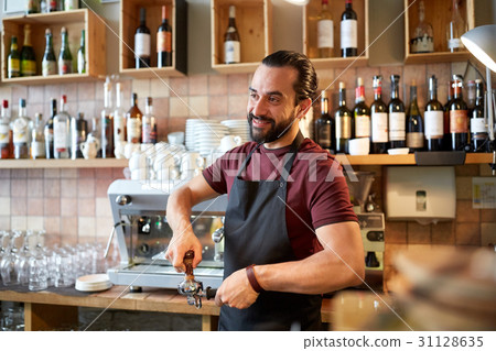 barista with holder and tamper making at coffee 31128635