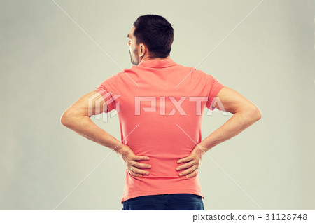 unhappy man suffering from backache at home 31128748