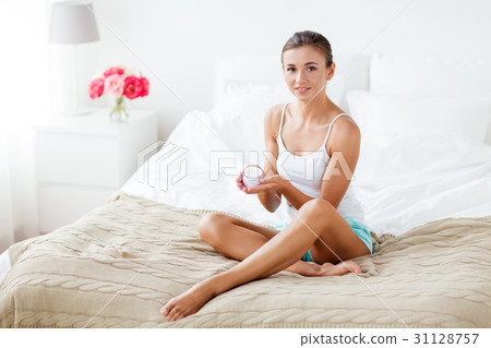 beautiful woman applying hand cream at home beautiful woman applying hand cream at home 31128757