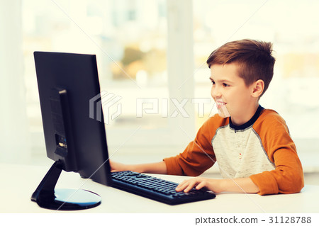 smiling boy with computer at home 31128788